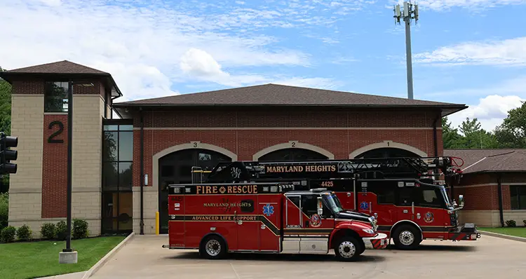 Engine House 2 on Dorsett Road, with an ambulance and Rescue Ladder 4425 parked in front of its three bay doors