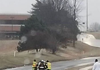 Maryland Heights Fire Protection District crew pushing stretcher up icy road to hospital
